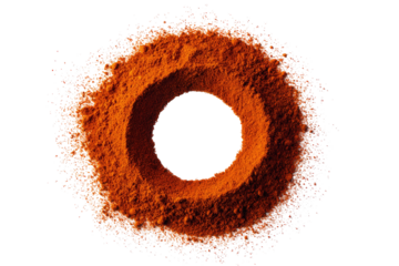 Circular arrangement of orange-brown powder with a dark hole in the center, surrounded by a halo of the same powder