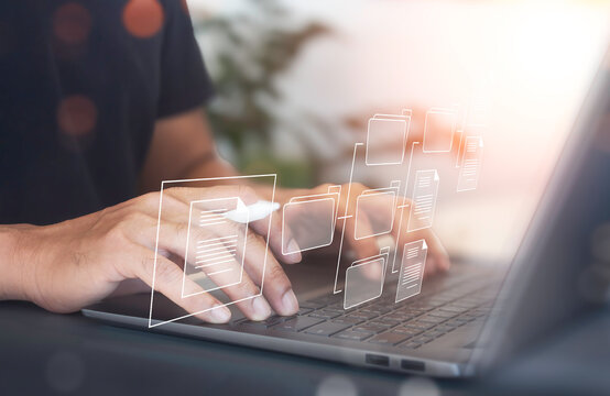 Document management system concept.  Businessman use laptop computer loading documents in online archives ,Document management Storage and technology on digital document paperless operation.