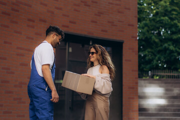 Courier delivering package to happy customer at home