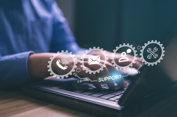 Fototapeta premium Person working on laptop with digital icons representing customer support, call center, online assistance, communication, and it services