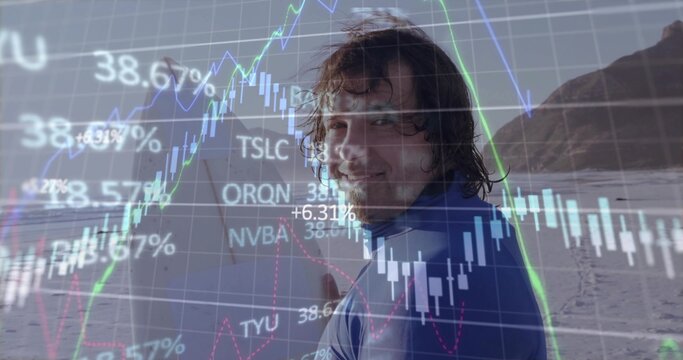 Standing surfer wearing blue wetsuit and holding surfboard at beach, financial charts overlay