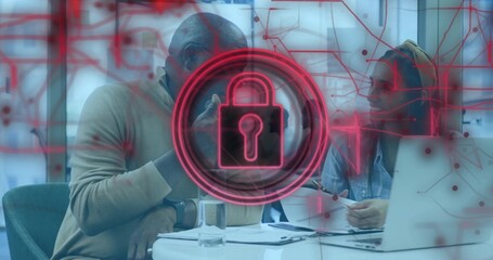 Two colleagues conducting secure data review at meeting table, with laptop, padlock network overlay