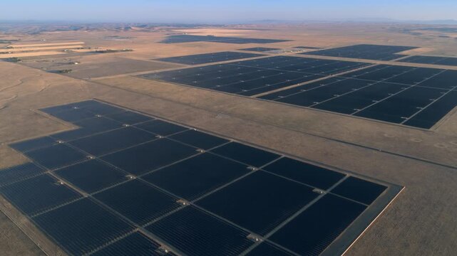 Aerial view of a large solar farm in Santa Margarita, California, USA. The panels are arranged in rows and columns, generating clean, renewable energy from the sun.