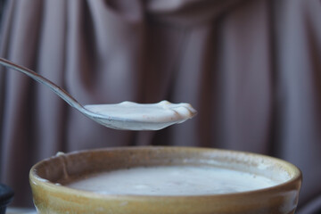 Delicious traditional yogurt soup served in clay bowl