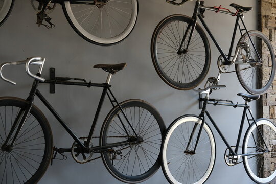 Classic Fixed-Gear Road Bikes Hanging on Wall as Interior Decor