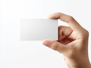 Child hand holding a blank white business card against a clean, bright white background