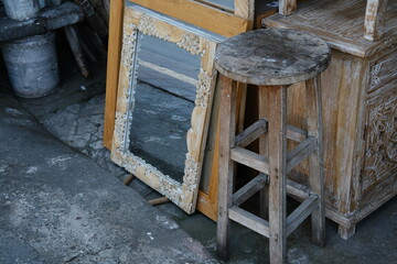 Old Wooden Bar Stool and Mirror on Sidewalk of Roadside Shop