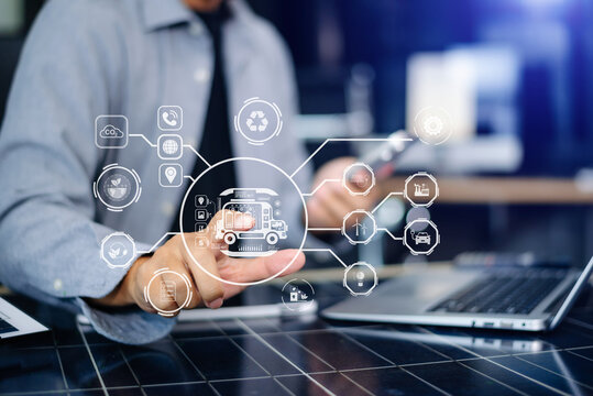 Engineer managing smart EV truck interface for clean logistics. Dashboard shows battery, solar, wind, CO2, and fleet icons in futuristic eco-transport tech network.