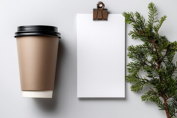 top view of paper coffee cup with copy space, blank white paper sheet and spruce branch on light background
