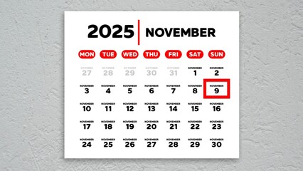 The date November 9th marked with a red cursor on the wall calendar 2025