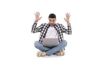 Young man sitting cross-legged with hands raised in joy, isolated, PNG