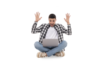 Young man sitting cross-legged with hands raised in joy, isolated, PNG