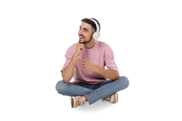 Young man joyfully listens to music with headphones on, isolated, PNG