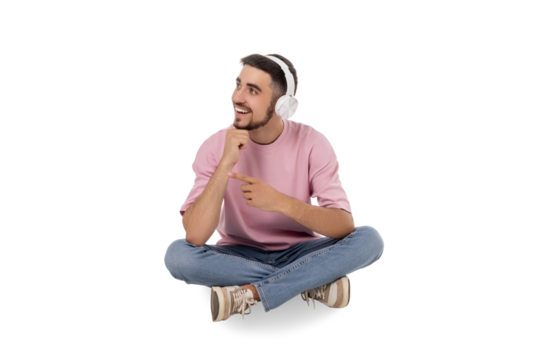 Young man joyfully listens to music with headphones on, isolated, PNG - Powered by Adobe