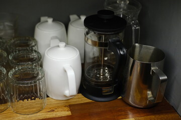 Glasses, Saucepans and French Press on Wooden Shelf