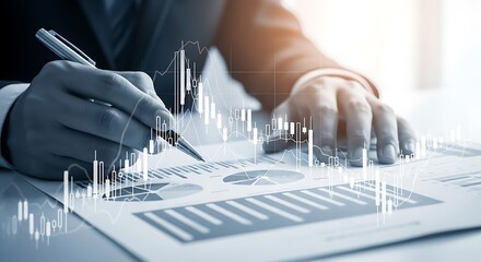 Businessman analyzing financial data reports with a digital overlay of stock market charts and graphs.