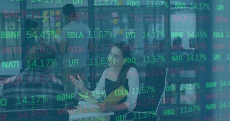 Gesturing female office worker holding yellow folder talking in modern office, with data overlays