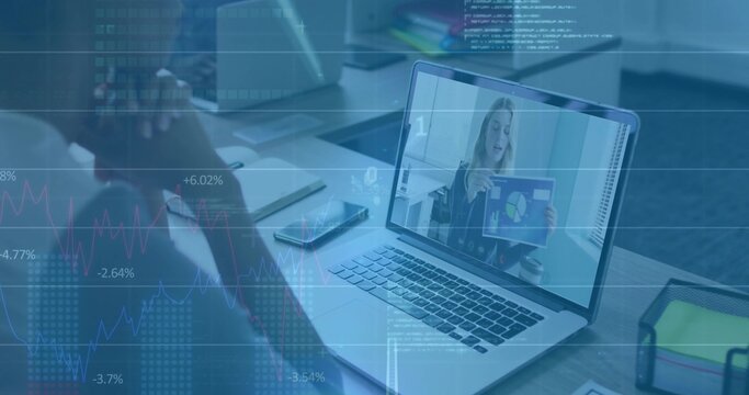 Laptop displaying remote presenter holding chart at desk in office, with data overlay and papers
