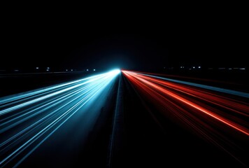 Abstract time-lapse view of road, streaks of blue & red light trailing from headlights on dark asphalt. Blurred motion