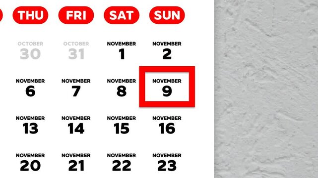 The date November 9th marked with a red cursor on the wall calendar 2025