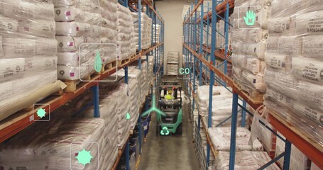 Driving forklift wearing yellow hard hat and vest through aisle, with stacked sacks and shelves