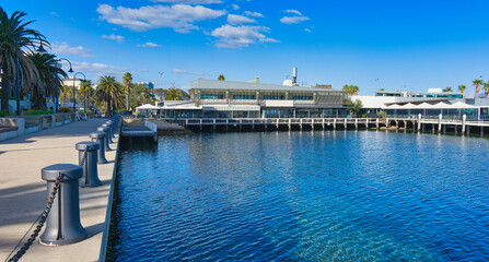 Waterfront dining area along palm tree esplanade