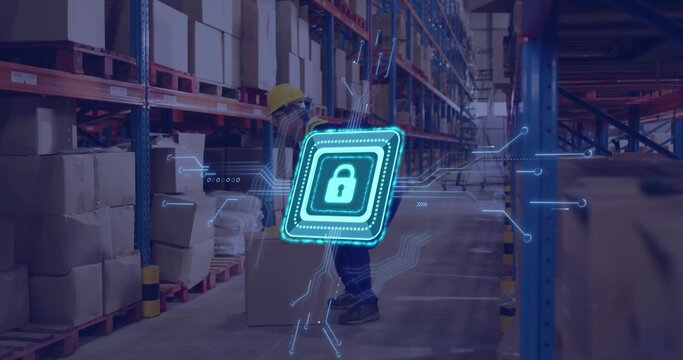 Male worker wearing hard hat lifting cardboard box in warehouse, with metal racks, padlock graphic
