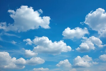 A bright, expansive, blue sky is dotted with puffy, white clouds creating a serene, open, and airy atmosphere during a sunny day