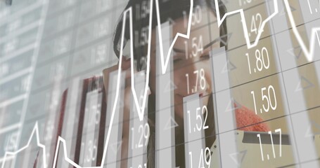 Examining businesswoman analyzing bar charts and line graph on digital display in office