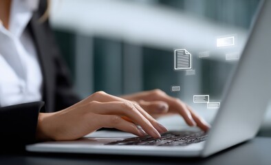 Businesswoman working on a laptop, managing digital documents stored in the cloud while enhancing office efficiency and data security