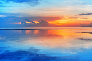 Sea beach sunset, calm ocean sunrise, beautiful peaceful tropical island landscape, idyllic seascape, colorful red orange yellow sky, golden sun reflection blue water, tranquil summer holidays, travel