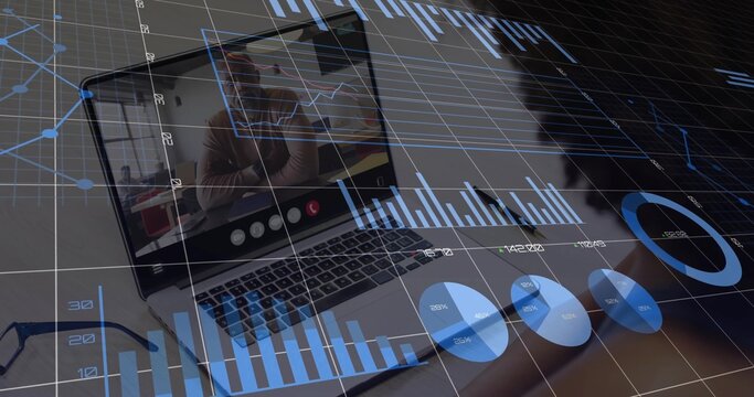 Laptop hosting call on wooden desk at home workspace, overlaying data charts with eyeglasses