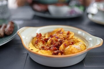 Closeup of baked potato and bacon in homemade sauce