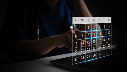Doctor selecting appointment date on digital calendar using laptop. Concept of healthcare scheduling, hospital booking system and online medical appointment reminder. Doctor appointment with patient.