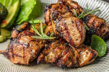 Grilled meat pieces with herbs and fresh vegetables on a plate © Надія Коваль