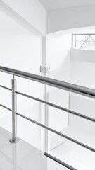 Fototapeta premium Modern Minimalist Interior with Stainless Steel Handrail and White Walls