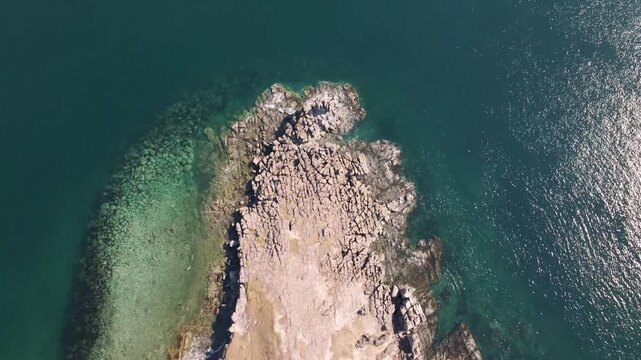 Basalt Columns of Bruce Cape. Aerial view of the basalt columns of Bruce Cape rising above the turquoise waters of the Sea of Japan in Primorsky Krai. Russia