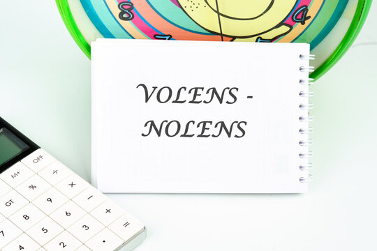 Willy - nilly latin expression volens-nolens (willing or unwilling) written on a white card