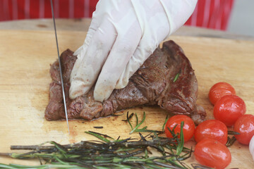 The steak is being cut with a knife.