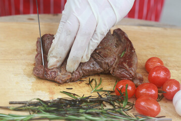 The steak is being cut with a knife.