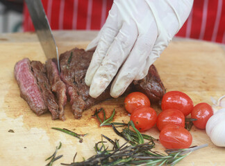 The steak is being cut with a knife.