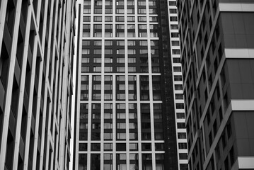 empty glass windows of a modern building with a reflection of the sky in the glass