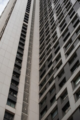 empty glass windows of a modern building with a reflection of the sky in the glass