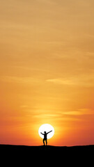 Silhouette of a person embracing Sunset: An emotive silhouette of a person stretches towards the vast, fiery sun, their arms wide open in a gesture of pure freedom.