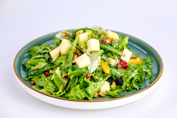 Plate of Fresh Vegetable Salad with Pomegranate Seeds and Cheese Cubes