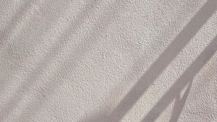 Rough texture of raw concrete wall background with sunlight and shadow on surface