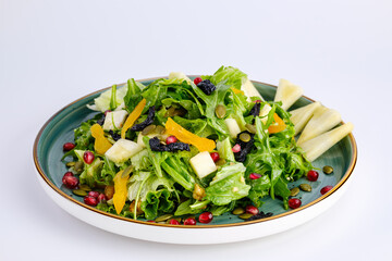 Plate of Fresh Vegetable Salad with Pomegranate Seeds and Cheese Cubes