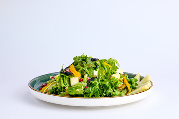 Plate of Fresh Vegetable Salad with Pomegranate Seeds and Cheese Cubes