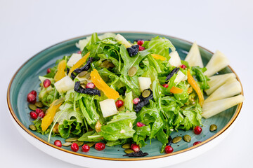 Plate of Fresh Vegetable Salad with Pomegranate Seeds and Cheese Cubes