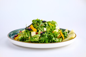 Plate of Fresh Vegetable Salad with Pomegranate Seeds and Cheese Cubes